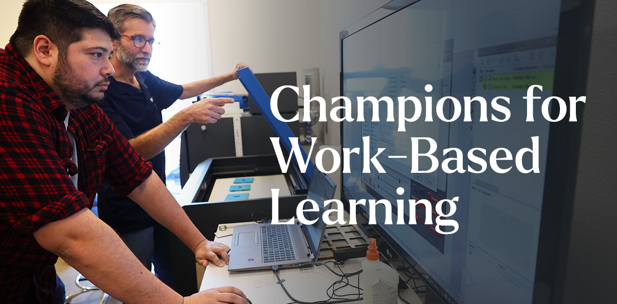 In white text says Champions for Work-Based Learning. There are two professionals in the background, looking at two computer screens.
