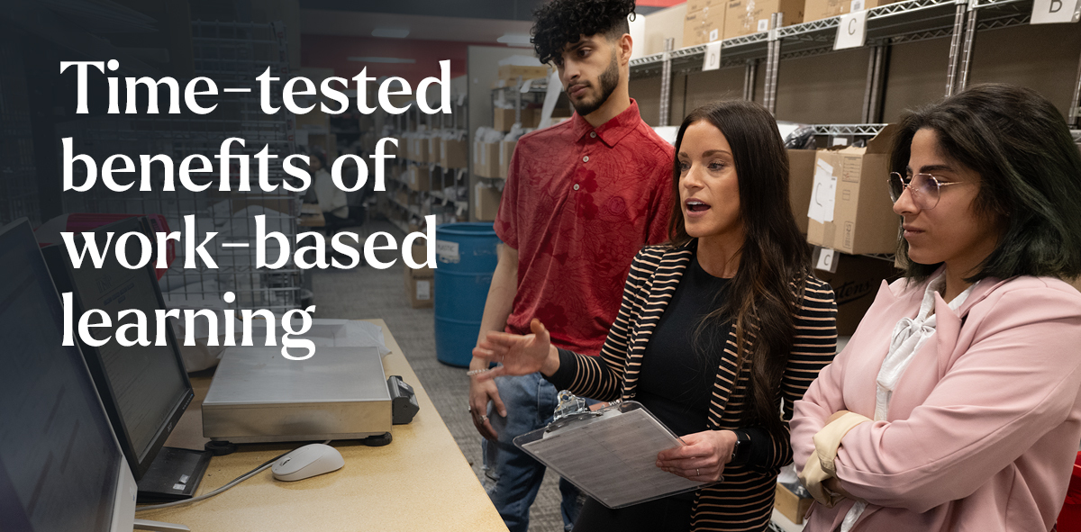 In white, text says time-tested benefits of work-based learning. There are professionals and students a like looking at a computer screen with a stacks of boxes behind them. 