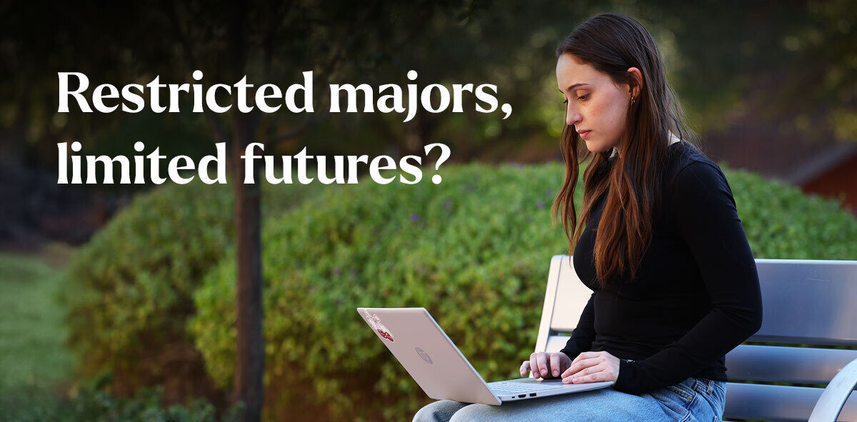 In white, text says Restricted majors, limited futures? There is a student wearing a black sweater sitting on a bench looking at their laptop.