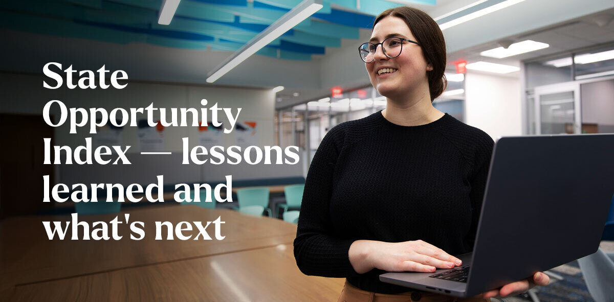 In white, text says State Opportunity Index — lessons learned and what's next. There is a student wearing black-framed glasses and a black shirt with a laptop on their hand, looking to the left.