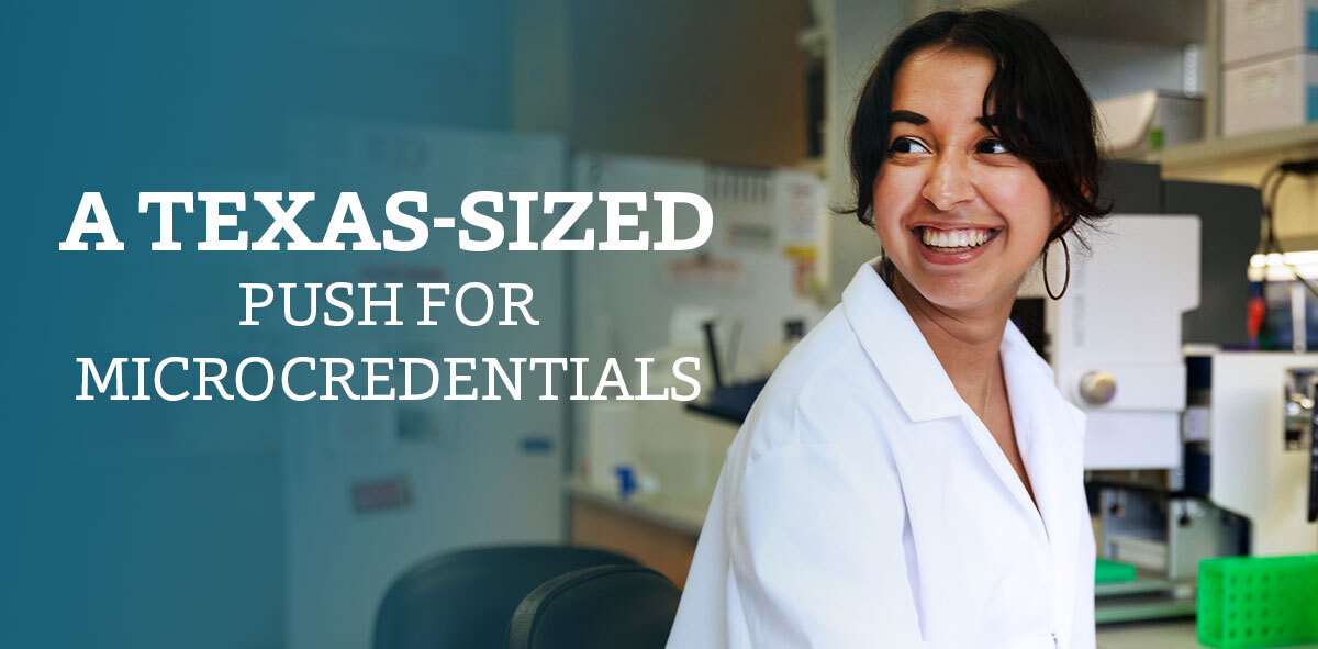 In white, text says A Texas-Sized Push for Microcredentials. There is a female student wearing a white lab coat smiling and looking to the right of her shoulder. There is a science laboratory in the background. 